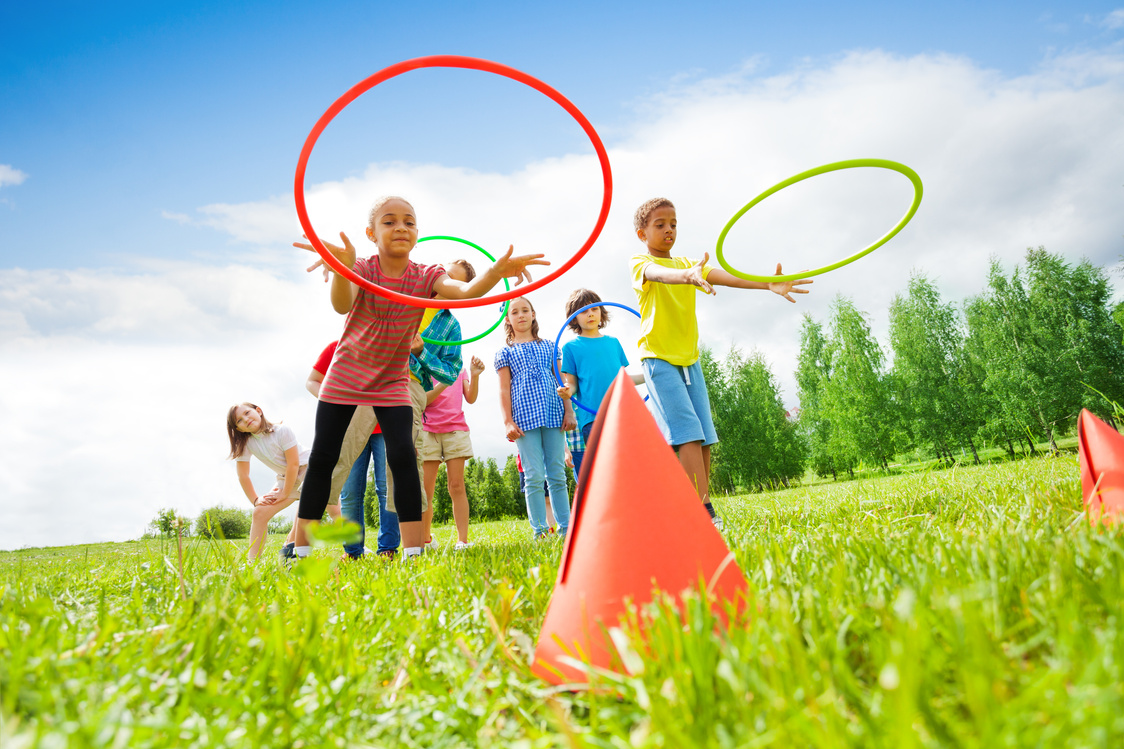 Kids Throw Colorful Hoops on Cones While Competing